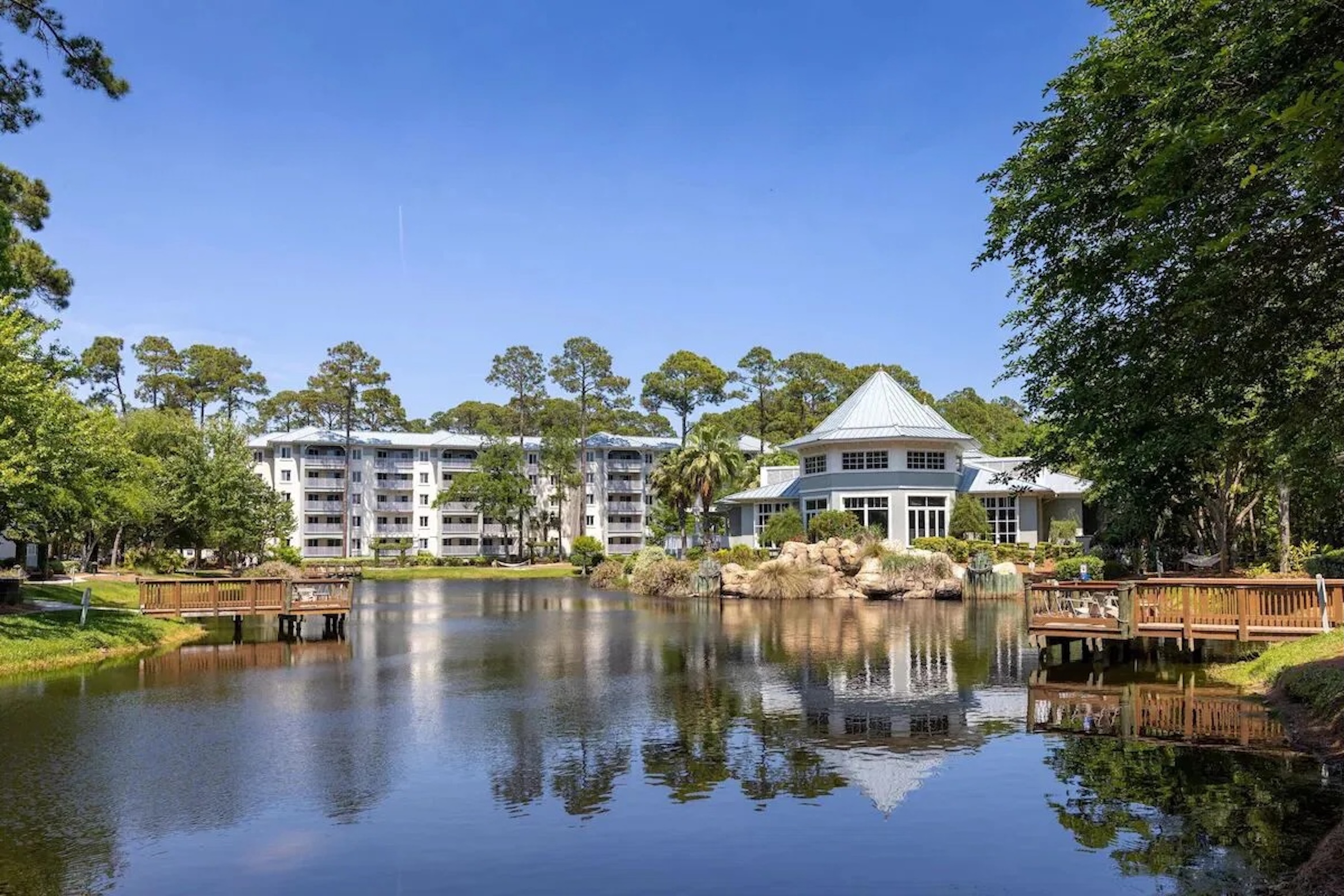 Scenic pond views with resort-style clubhouse and peaceful wooded setting