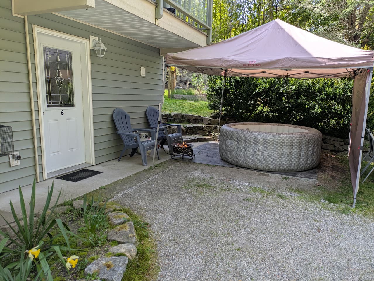 The entrance to the suite, which includes the propane fire bowl and hot tub, is located next to the parking area.