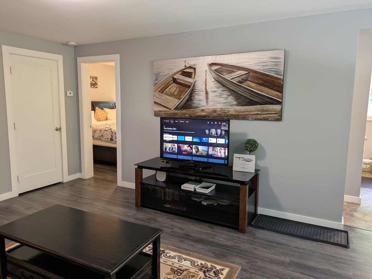 The bedroom is just to the left of the living room. There is a small utility room to the far left where the sofa bed mattress and bedding resides.