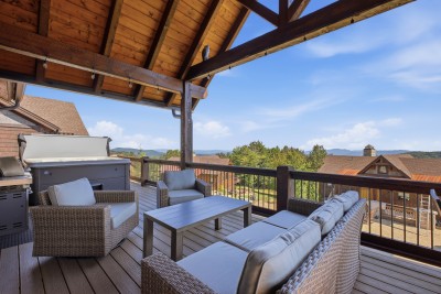 Unwind on the covered back deck with long-range views, soak in the hot tub under the stars, fire up the grill for a mountain cookout, and stretch out in the lounge seating — outdoor living at its finest.