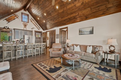 Take in the great room's dramatic ceiling and rustic ski accents from the leather recliner, with barstool seating and a scenic backdrop perfect for group hangs or quiet evenings alike.