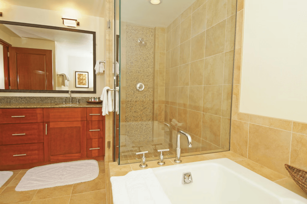 Spa-style bathroom with soaking tub, glass shower, and elegant vanity