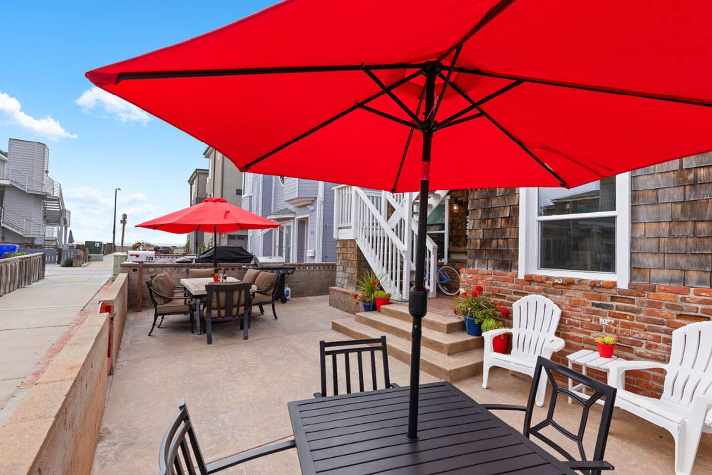 Enjoy drinks in the shared courtyard. The table with four chairs and adjacent BBQ are assigned to this unit.