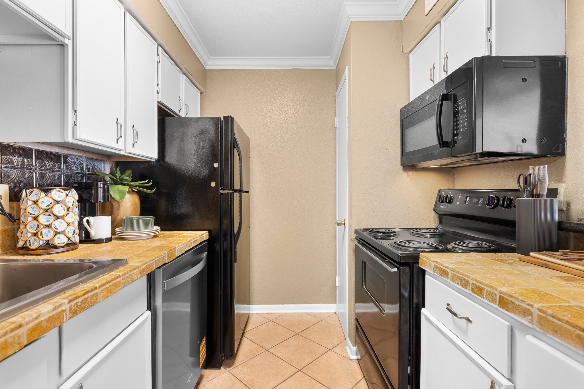 Bright galley kitchen with full-size appliances and guest-ready essentials