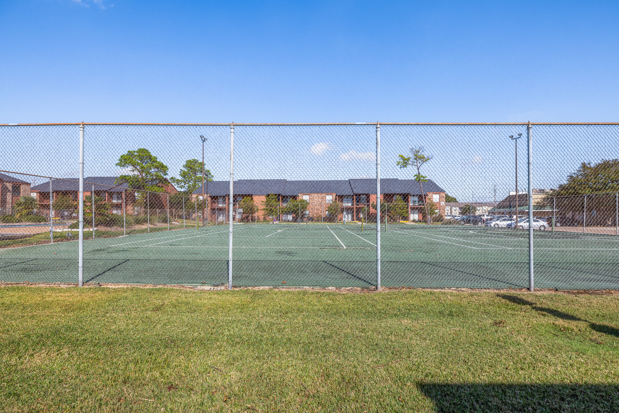 Enjoy access to a fenced community tennis court under sunny open skies