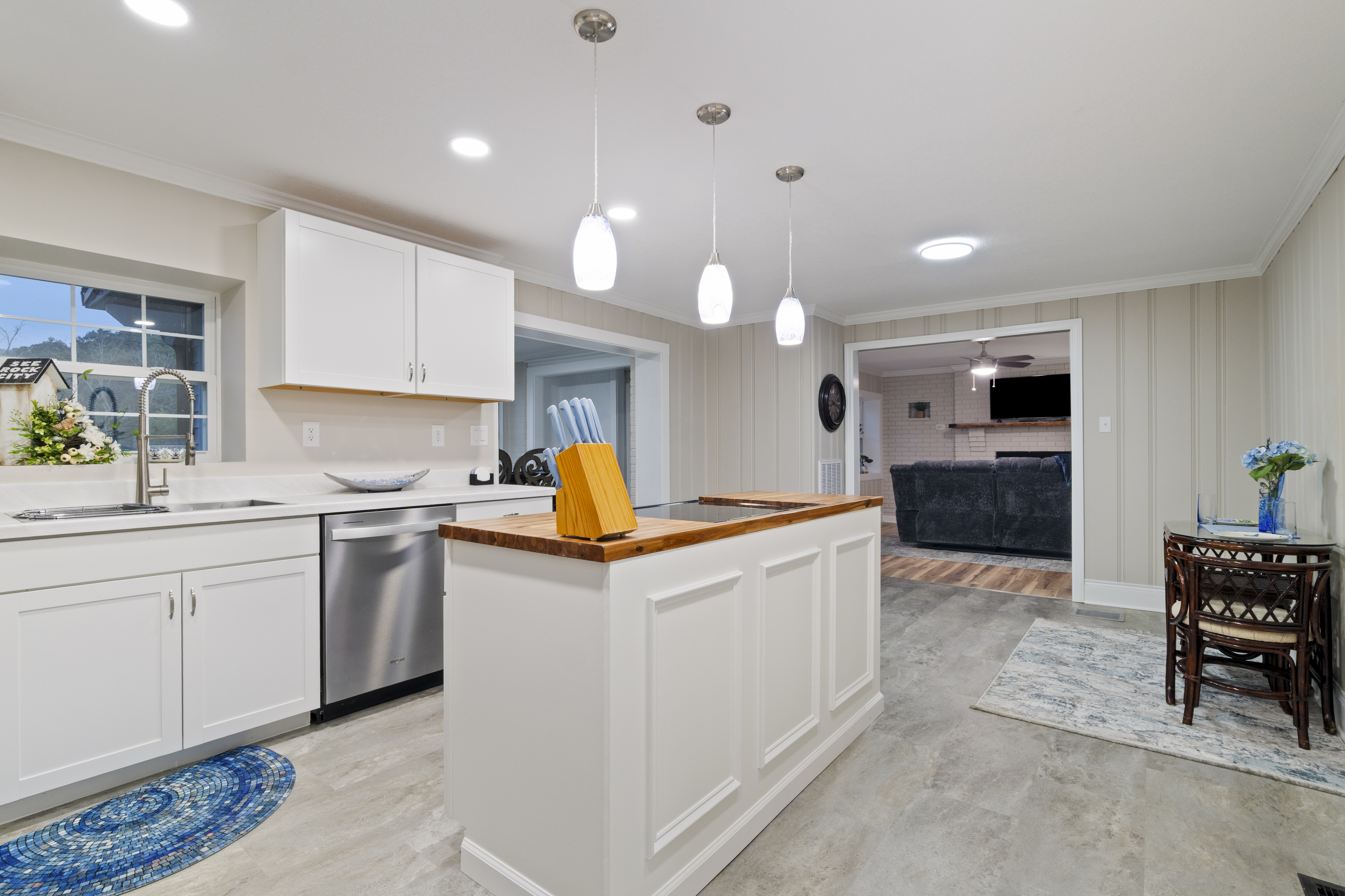Bright modern kitchen with island seating potential and open living flow