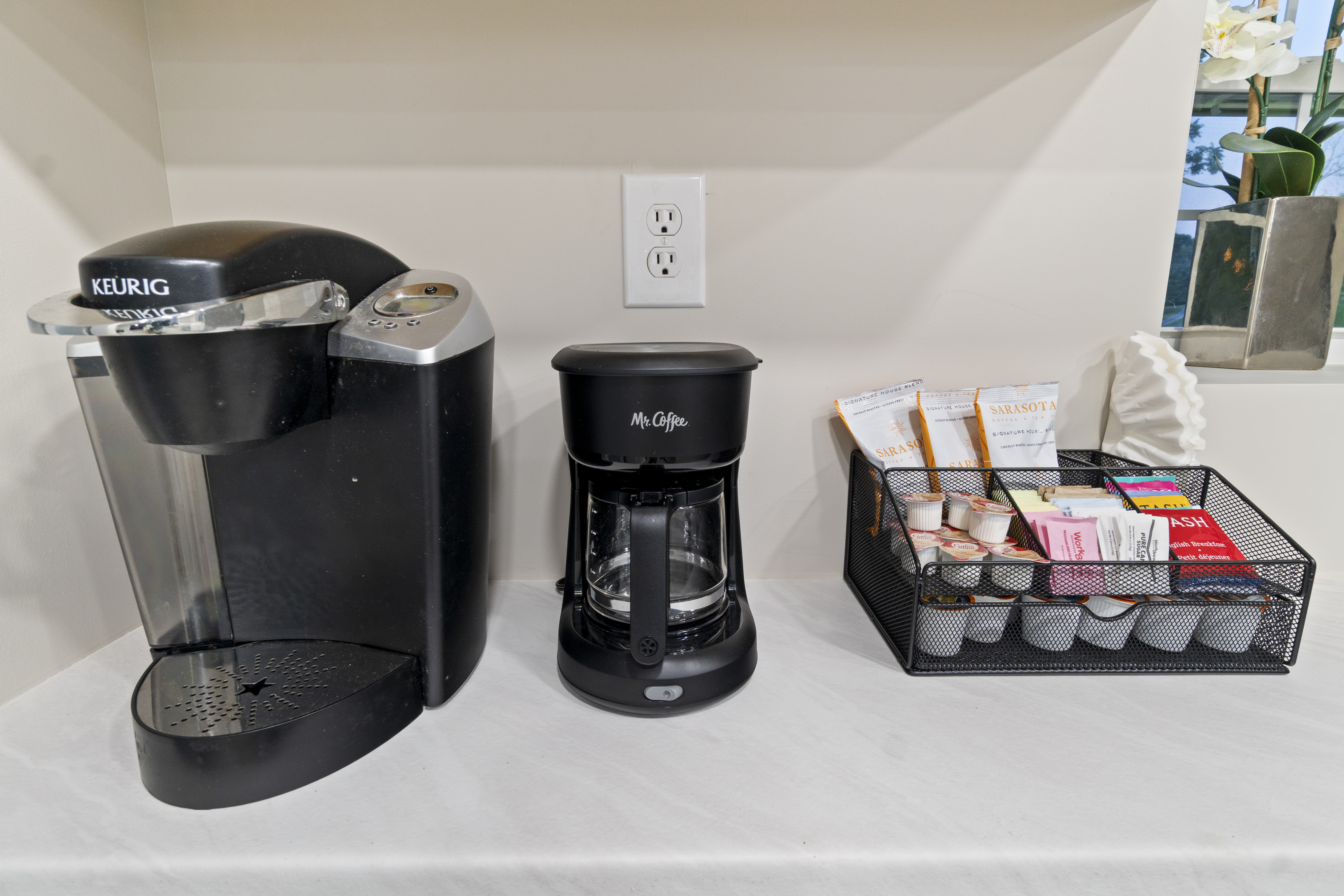 Stocked coffee station with Keurig, drip brewer, and tea essentials