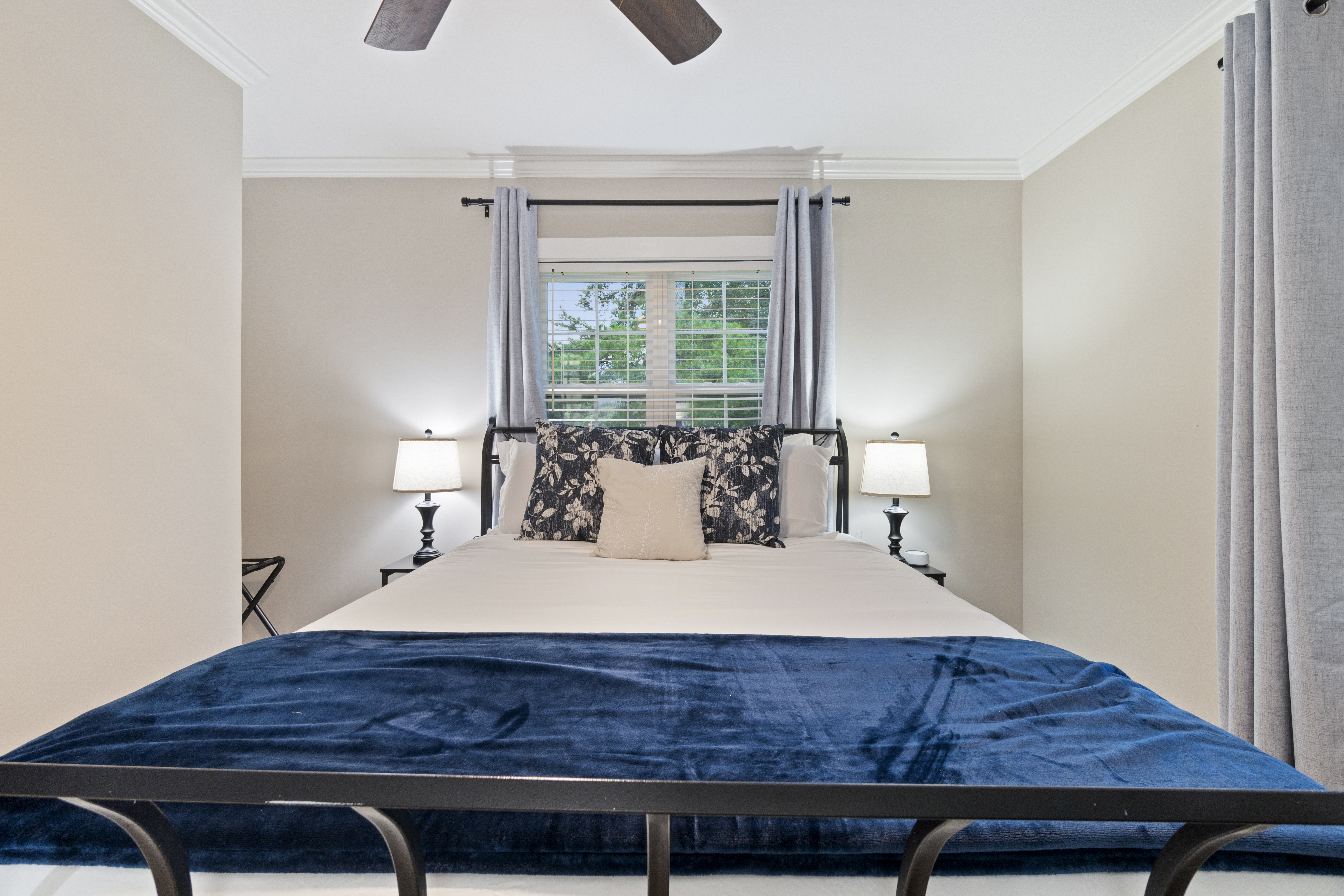 Bright, cozy bedroom with elegant navy accents and peaceful window views