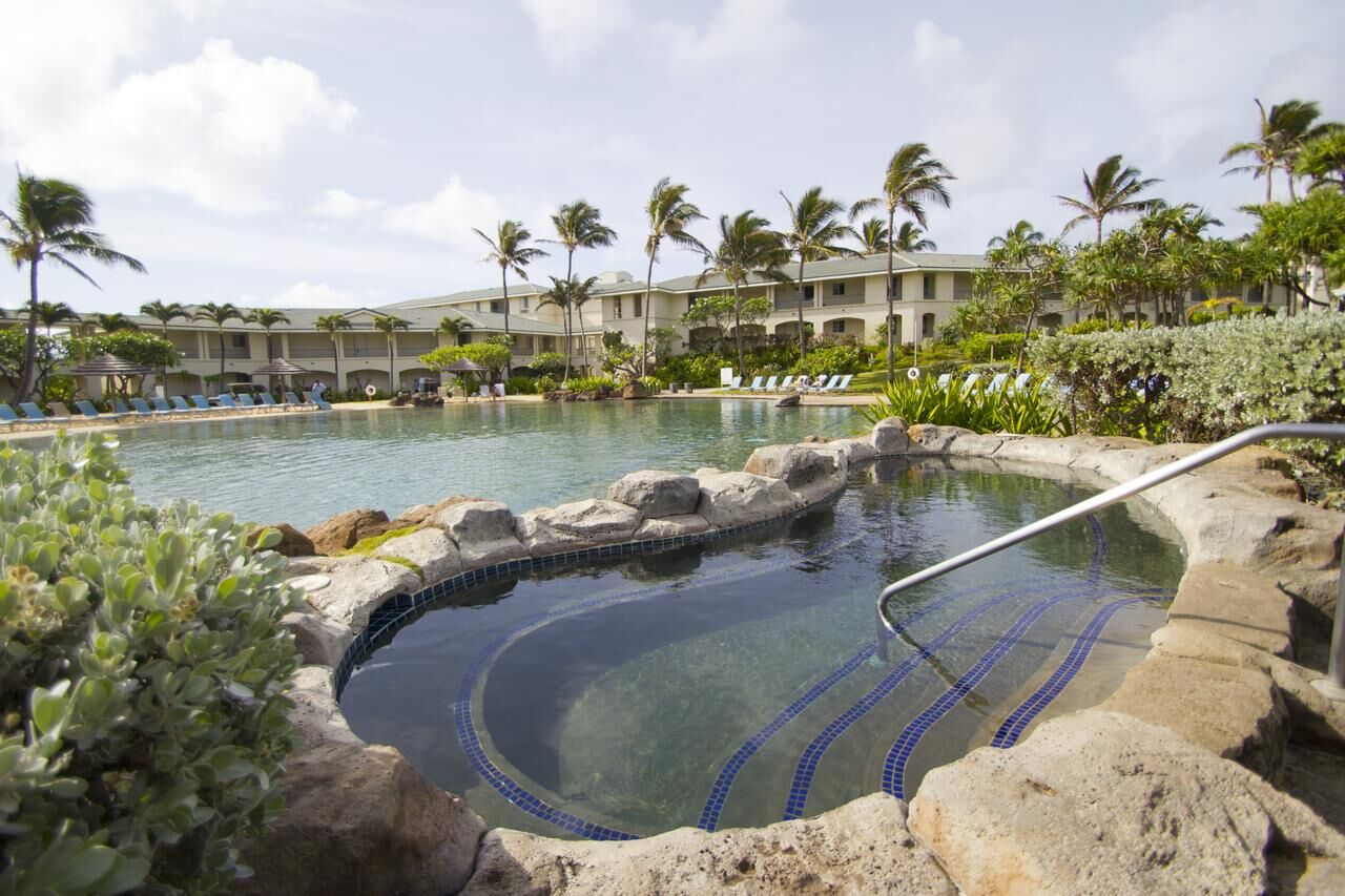 Tropical lagoon pool and spa surrounded by palms and resort-style lounging