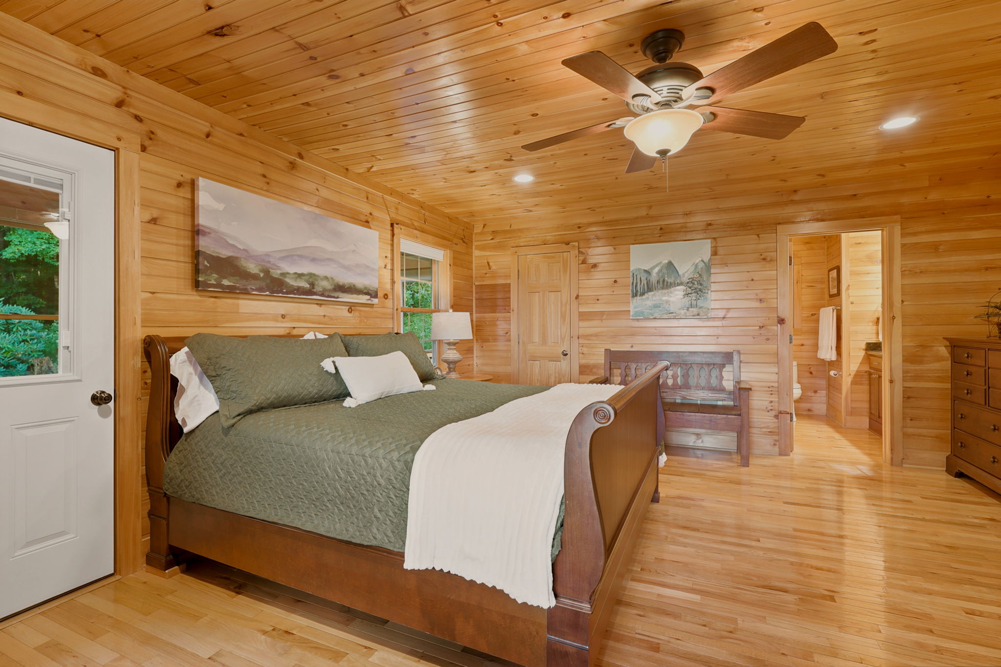 Spacious primary bedroom with king sleigh bed