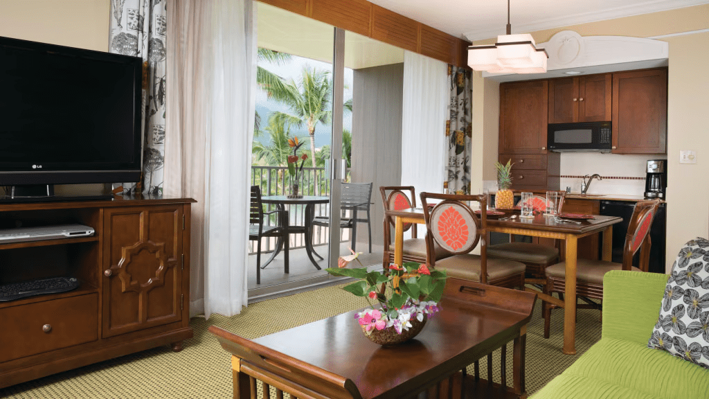 Bright island-style suite with dining area and lanai with tropical views