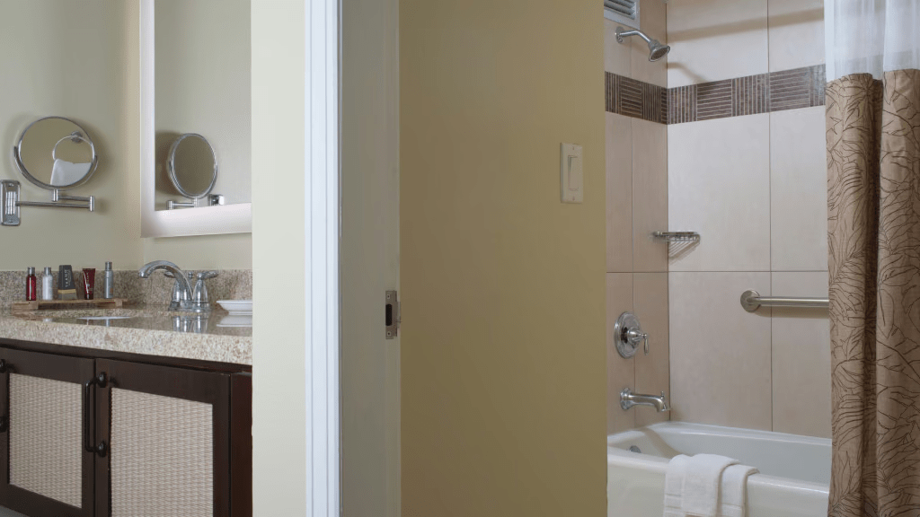 Bright bathroom with granite vanity and tiled tub-shower combo