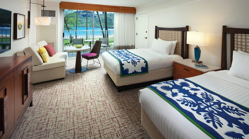 Bright double-queen room with lanai seating and beautiful ocean views