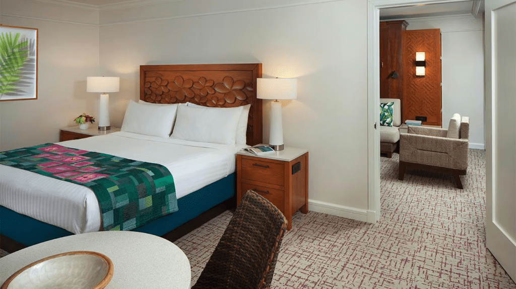 Spacious king bedroom with cozy sitting area and warm island-inspired decor
