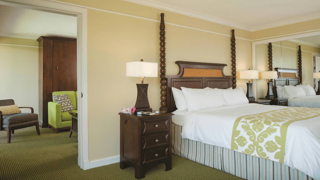 Spacious king suite with elegant wood accents and separate sitting area