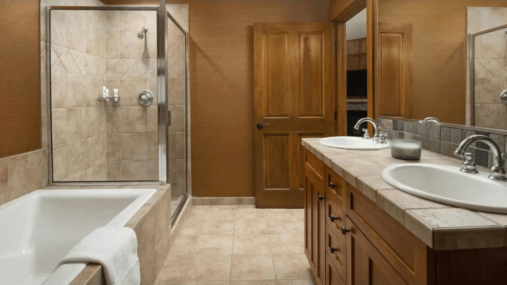 Spacious spa-style bathroom with double vanity, soaking tub, and glass shower