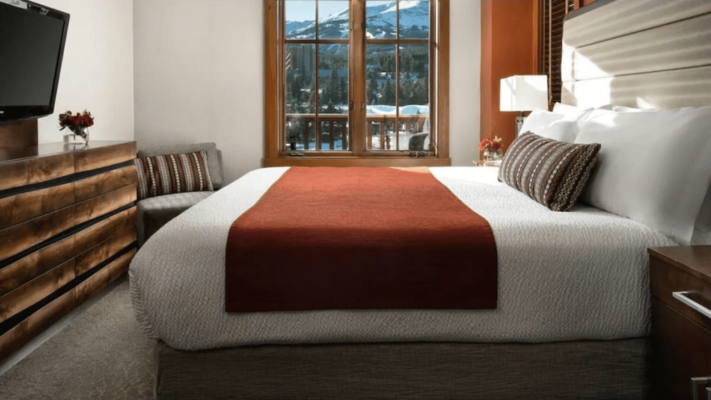 Cozy mountain-view bedroom with plush king bed and warm modern style