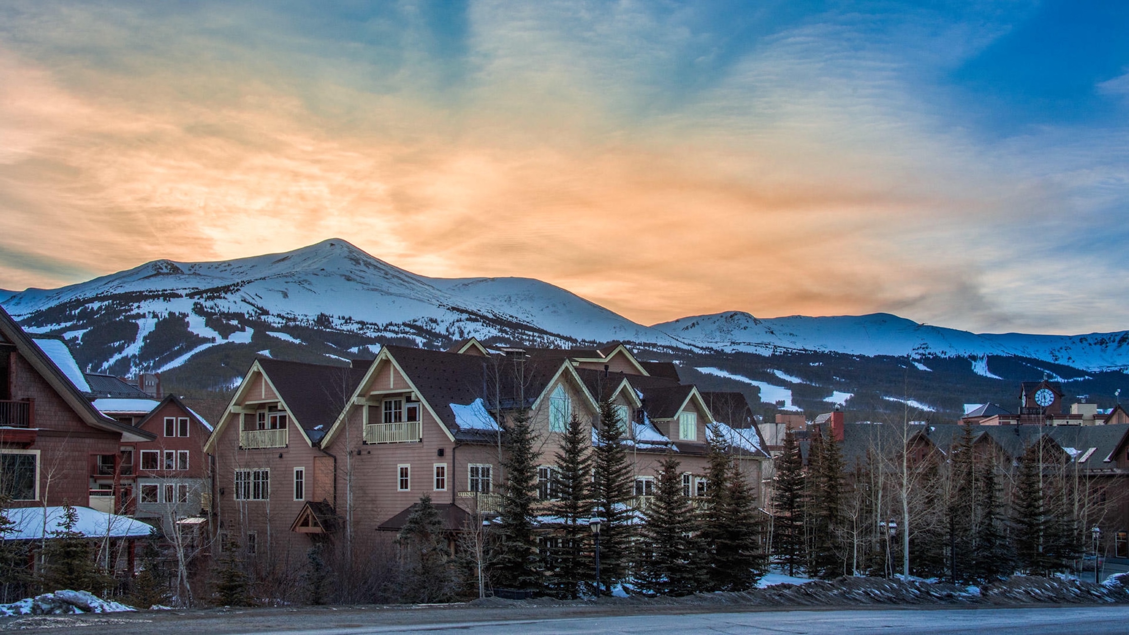 Mountain lodge retreat with sunset views and snowy alpine backdrop