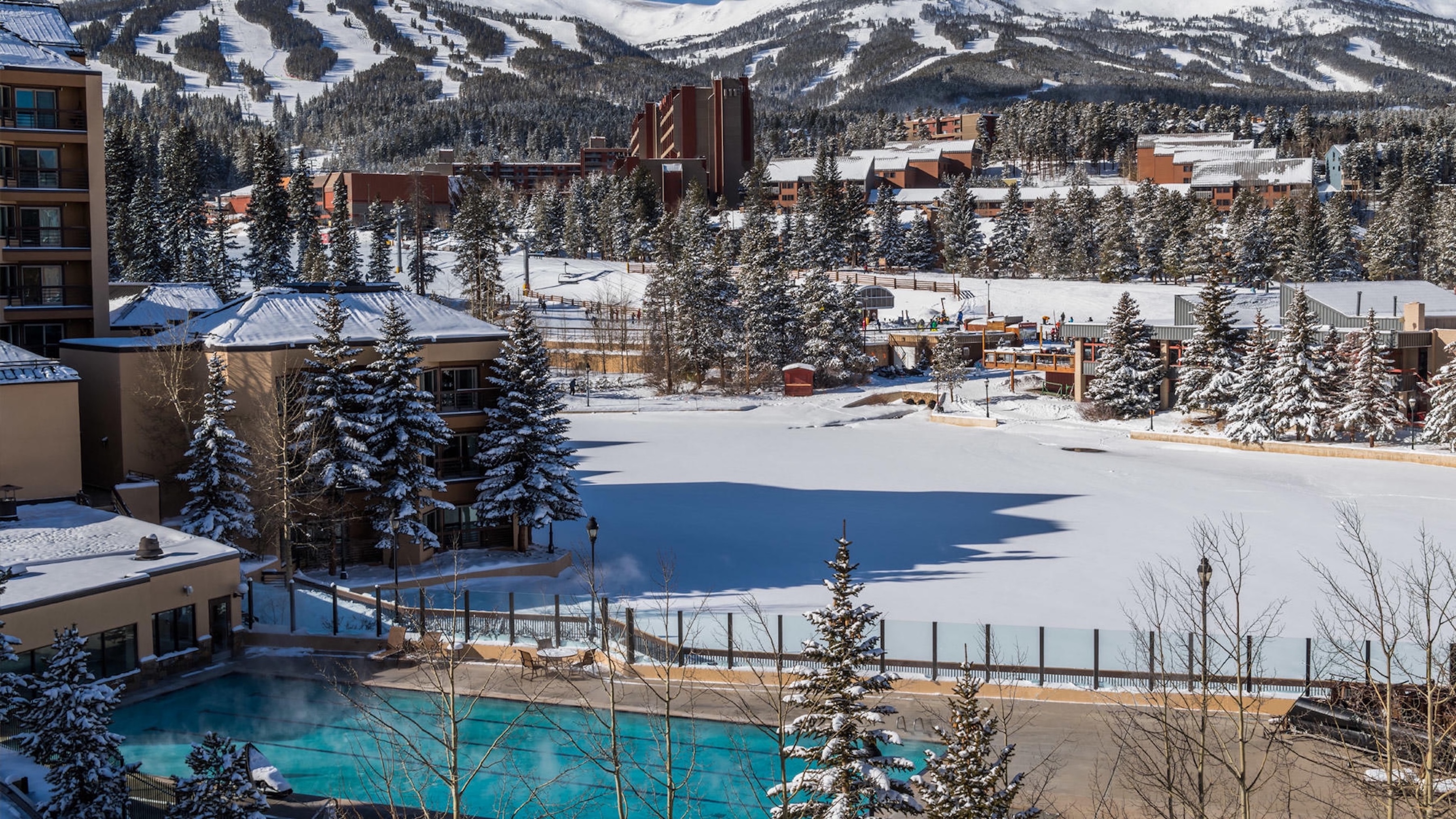 Heated outdoor pool with stunning snowy mountain and ski slope views
