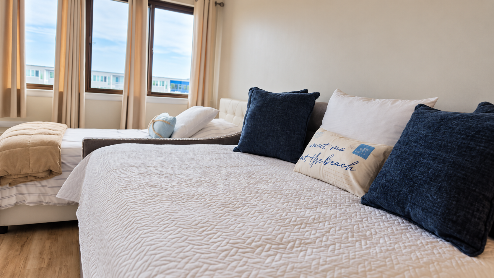 Bright bedroom with two comfy beds and soft coastal touches