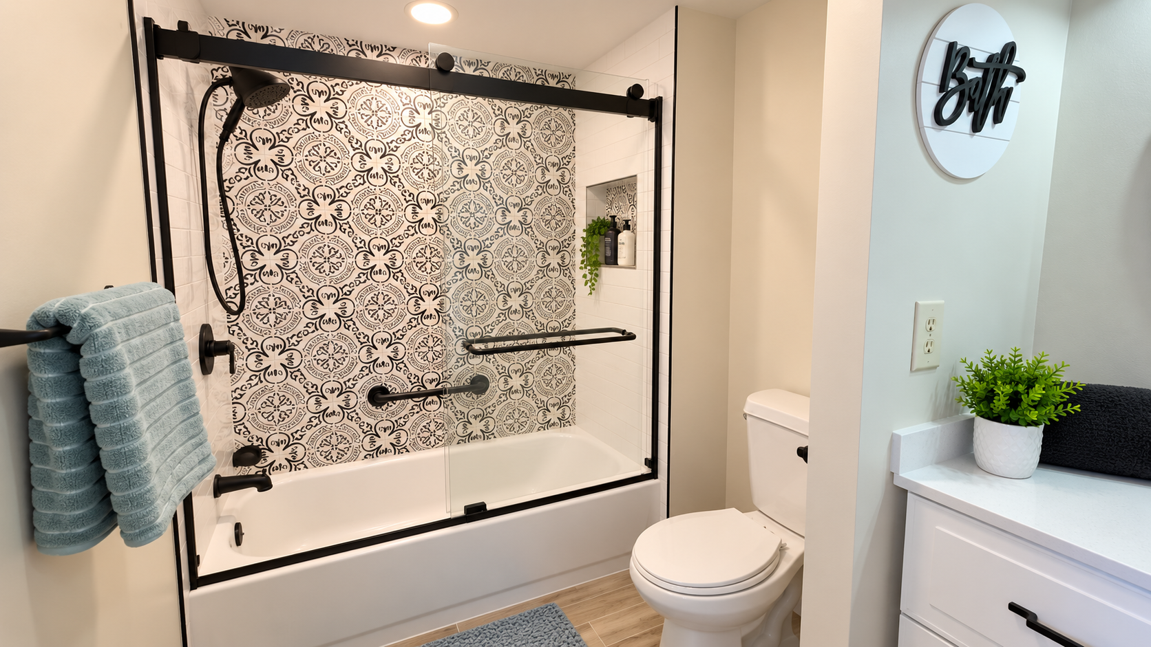 Stylish modern bathroom with patterned tile and sleek glass tub shower