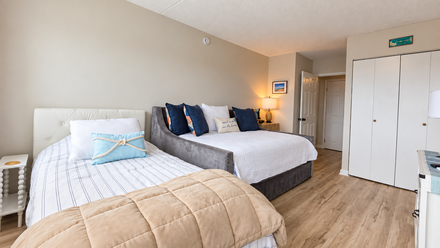 Bright family-friendly bedroom with two beds and ample storage