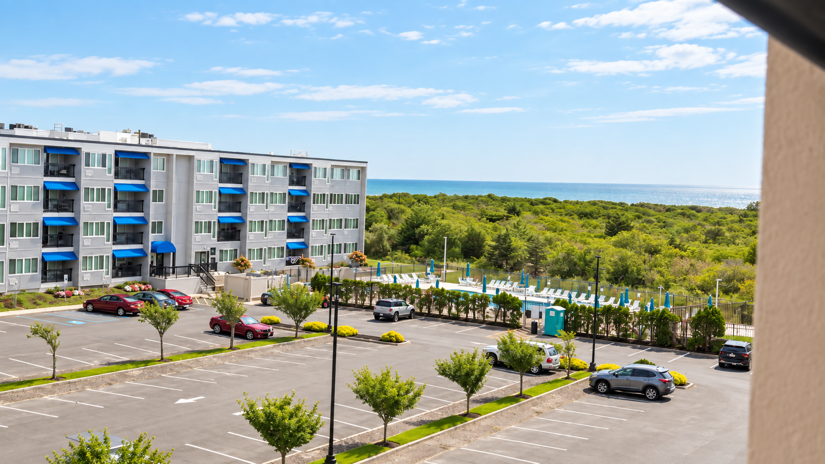 Coastal condo views with pool access and ocean on the horizon