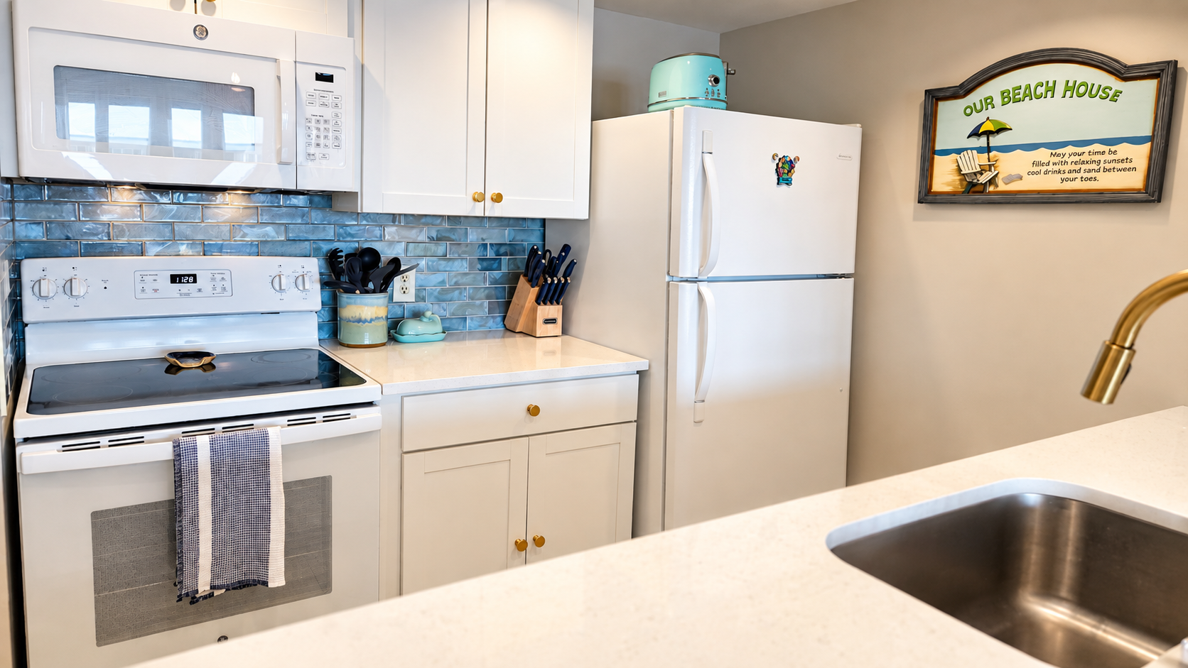 Bright beachy kitchen with full-size appliances and stylish blue backsplash