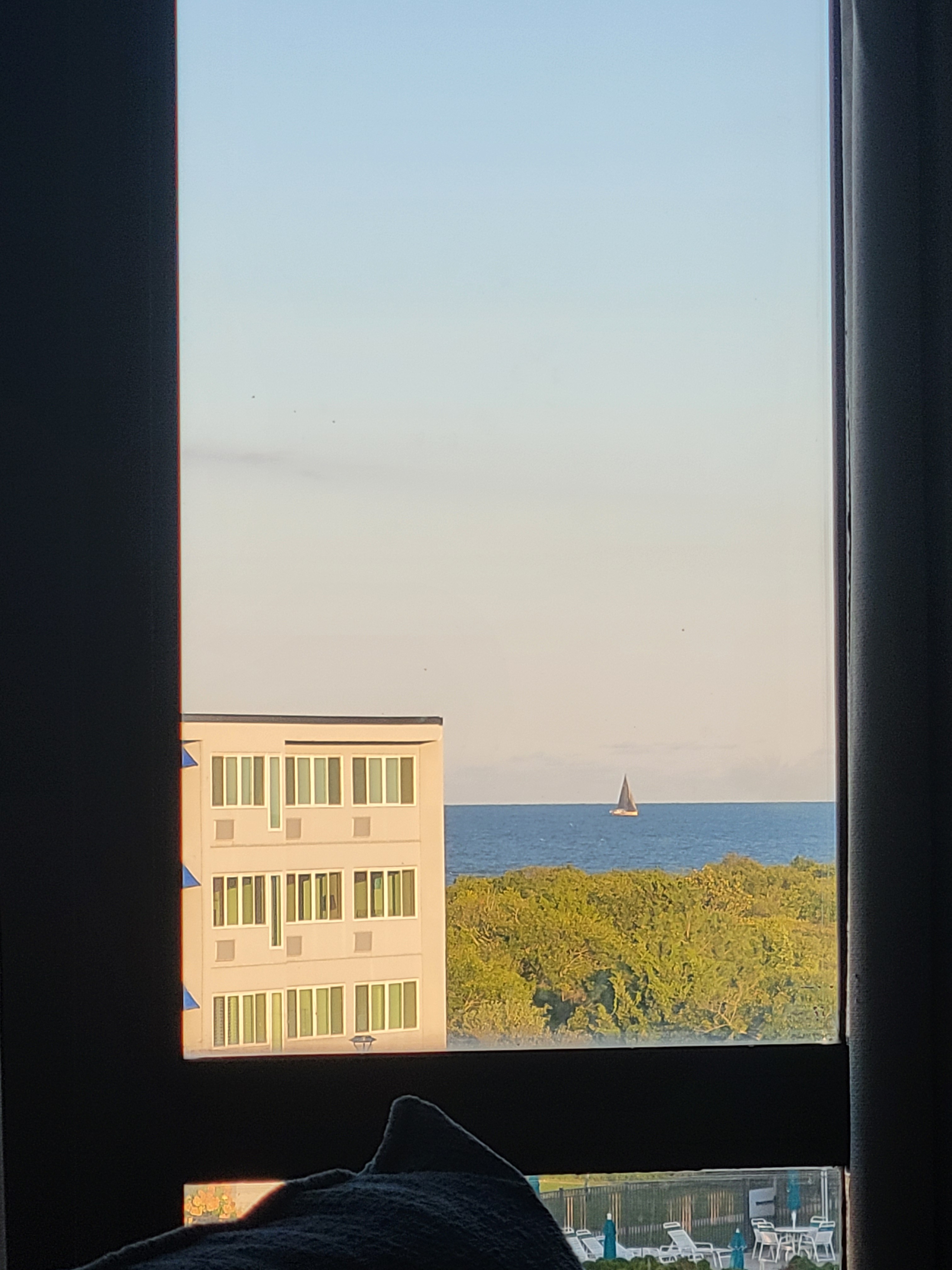 Peaceful waterfront view with large windows and coastal scenery