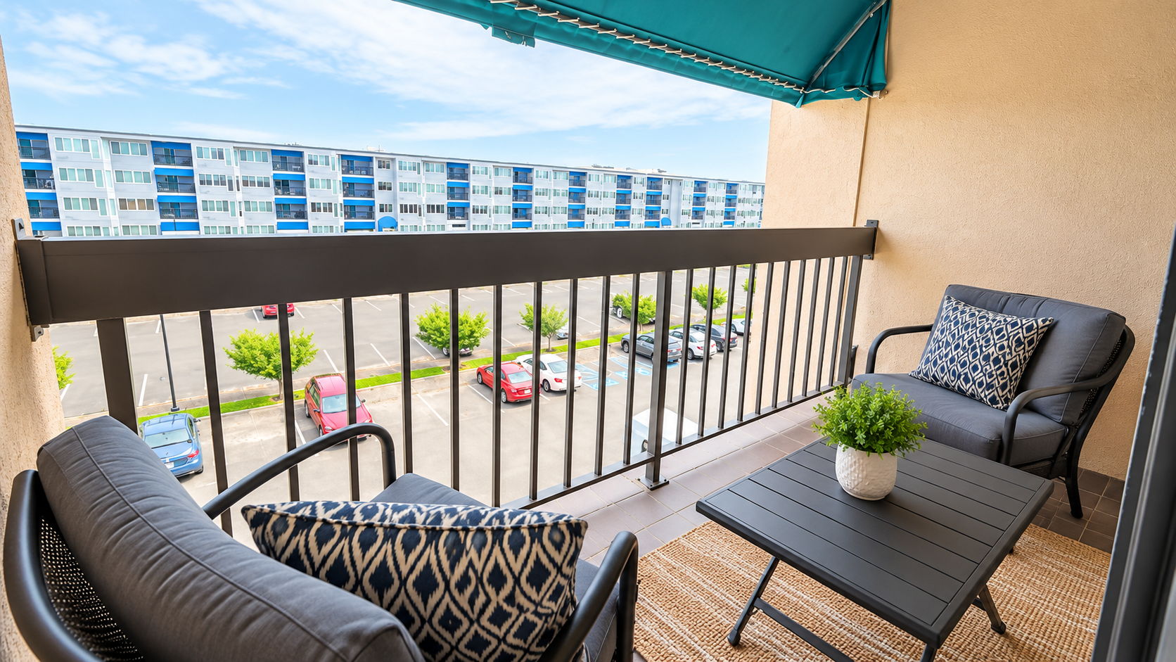 Covered private balcony with cozy seating and relaxing outdoor space