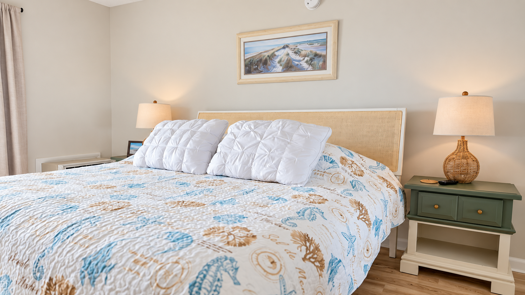 Coastal-inspired bedroom with a cozy king bed and warm bedside lighting