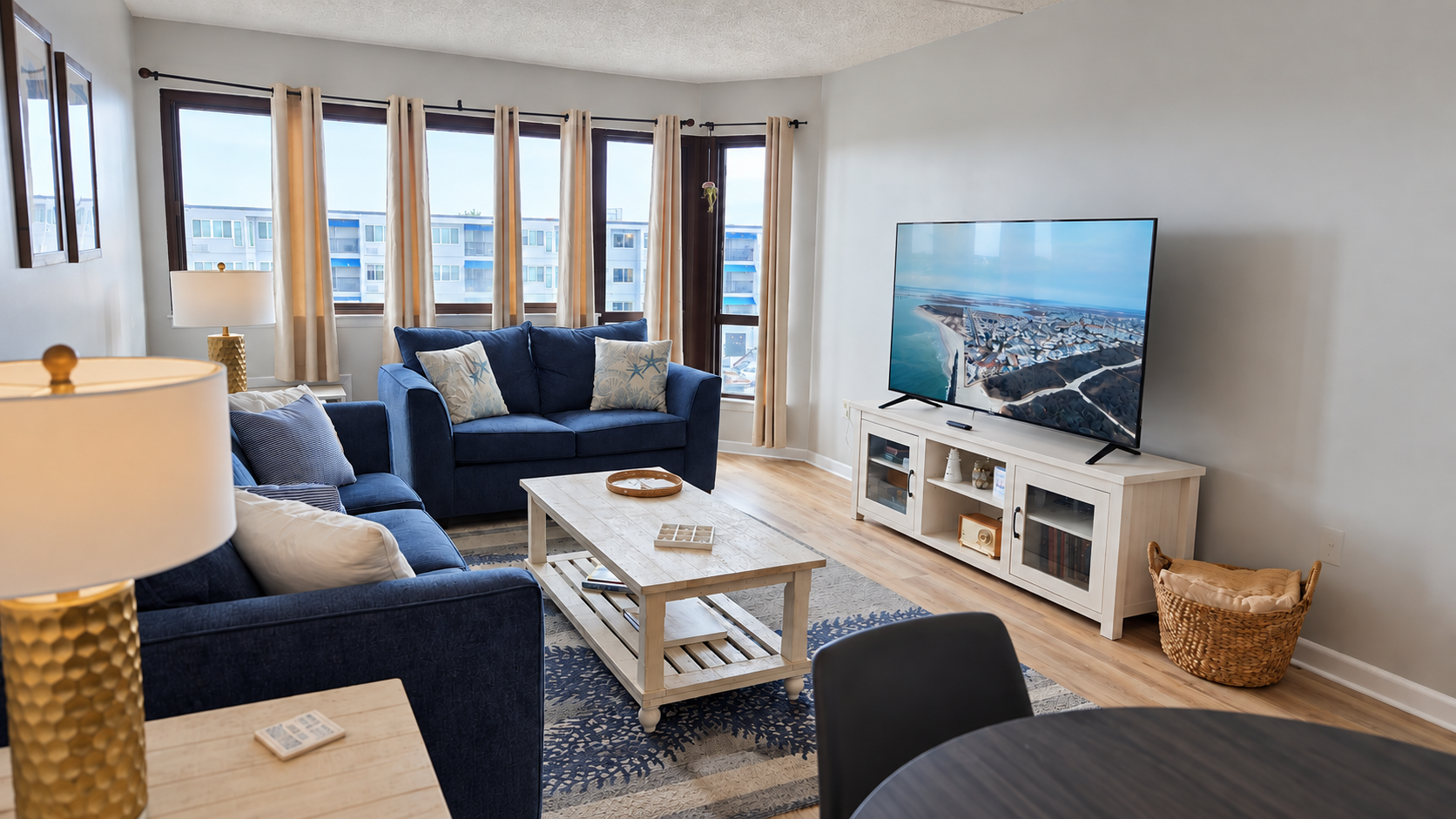 Bright, airy living room with plush seating, big TV, and natural light