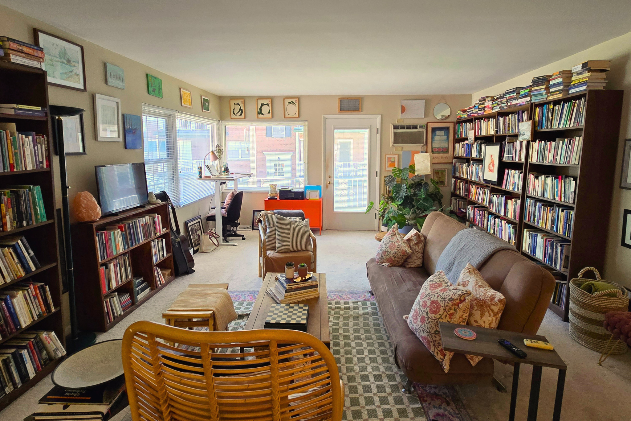Cozy book-filled living room with natural light and inviting seating