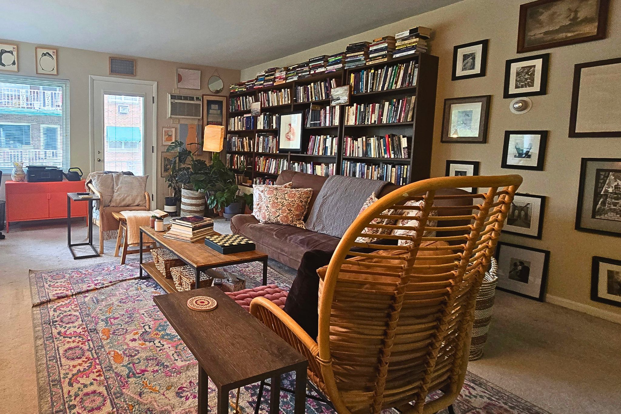 Cozy book-lined living room with eclectic decor and natural light