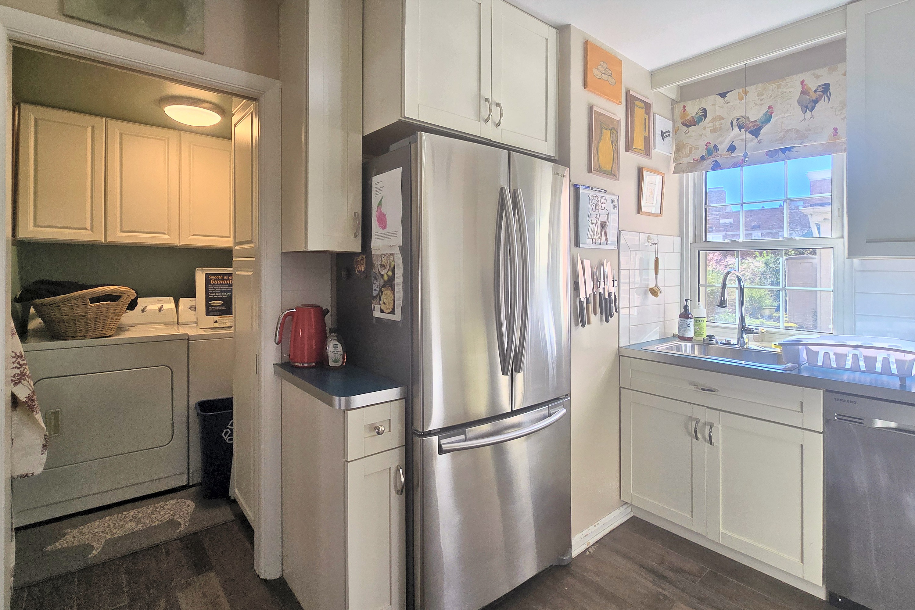 Bright kitchen with stainless appliances and convenient in-unit laundry