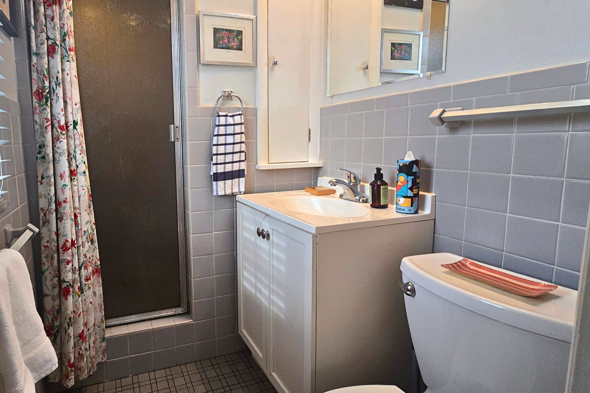 Bright tiled bathroom with walk-in shower and charming classic details