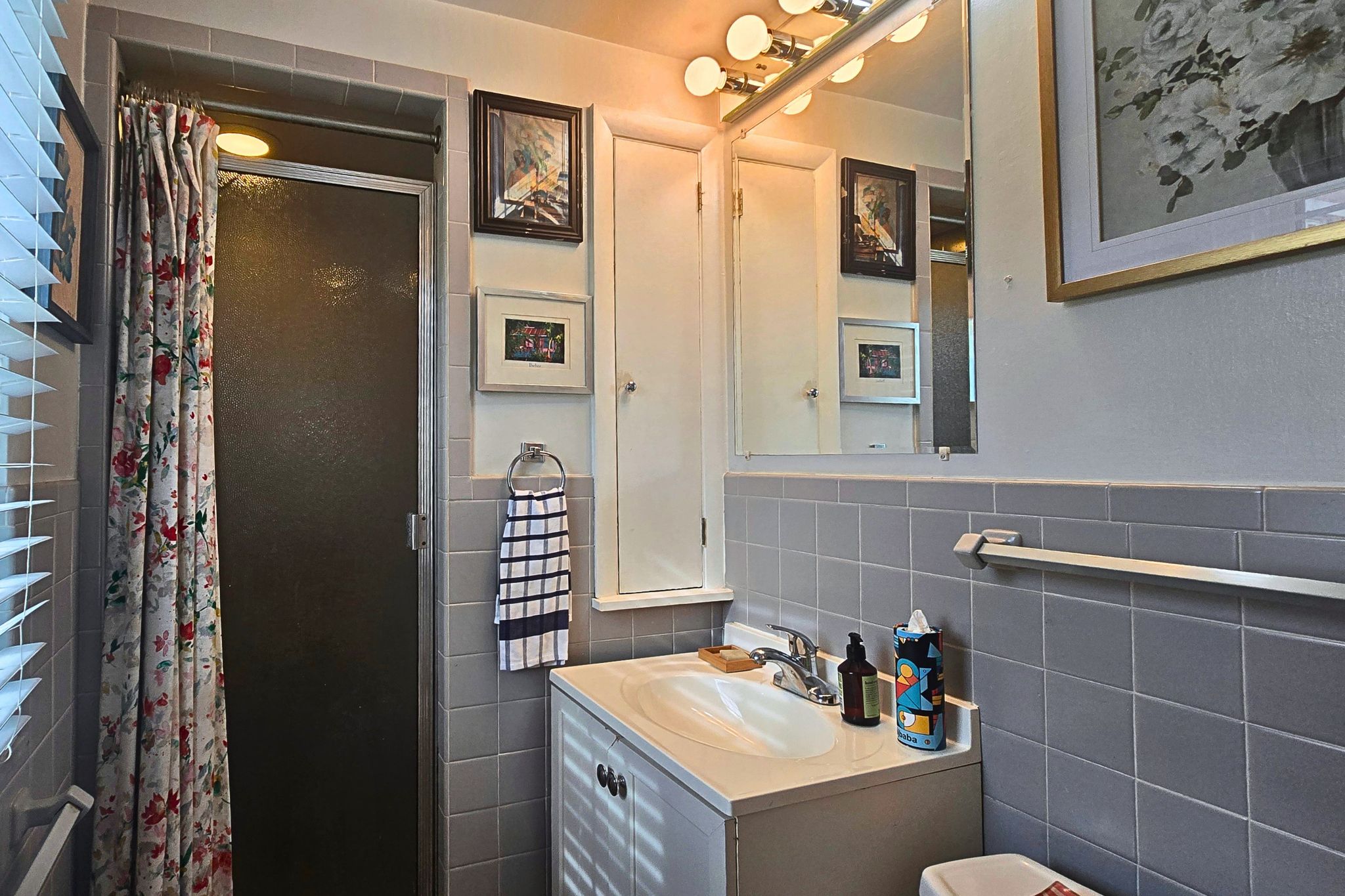 Bright, charming bathroom with natural light and a glass-enclosed shower