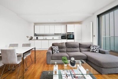 Open kitchen and living area with large grey sofa