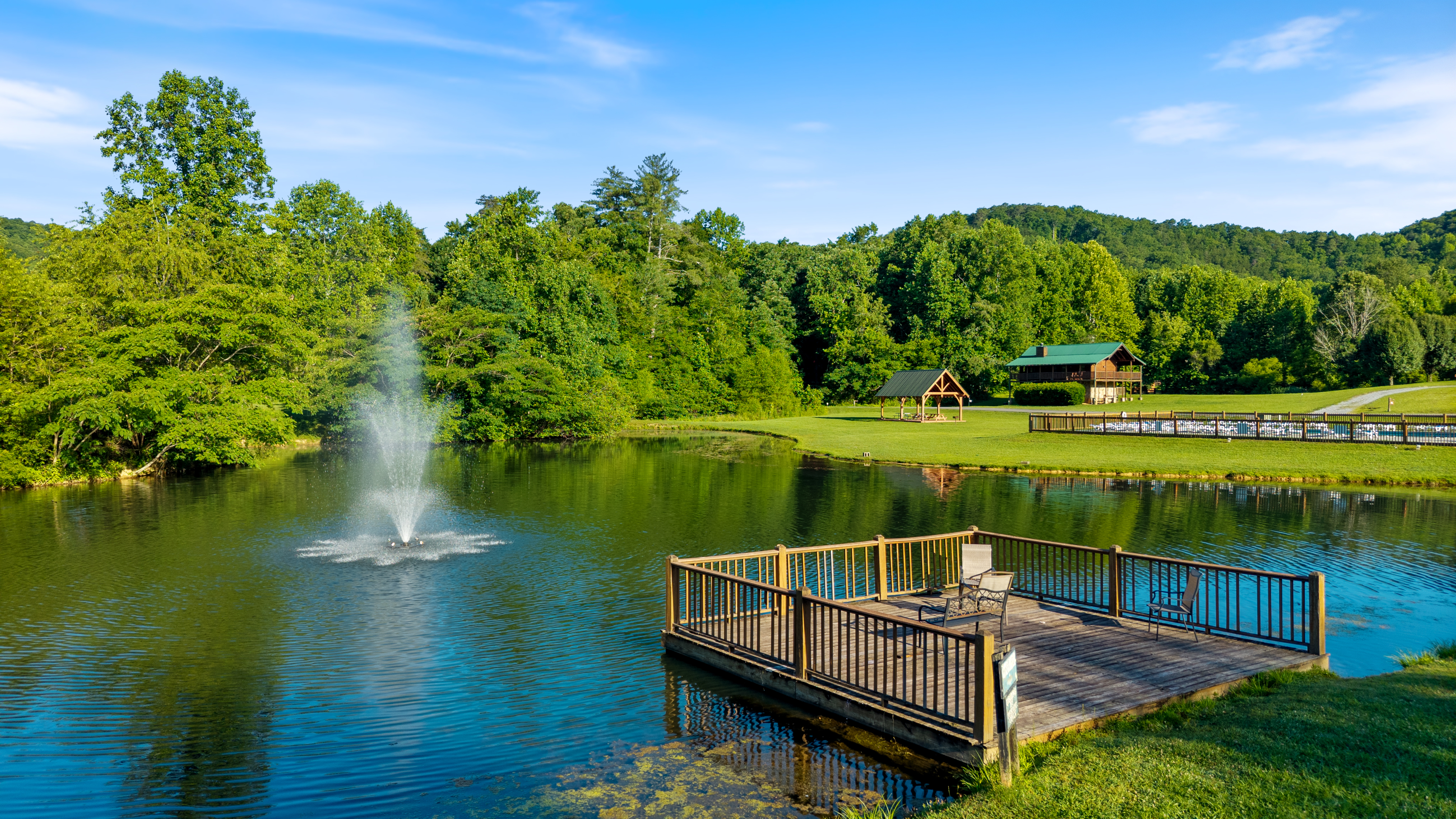 The community pond with a fountain and a viewing deck.