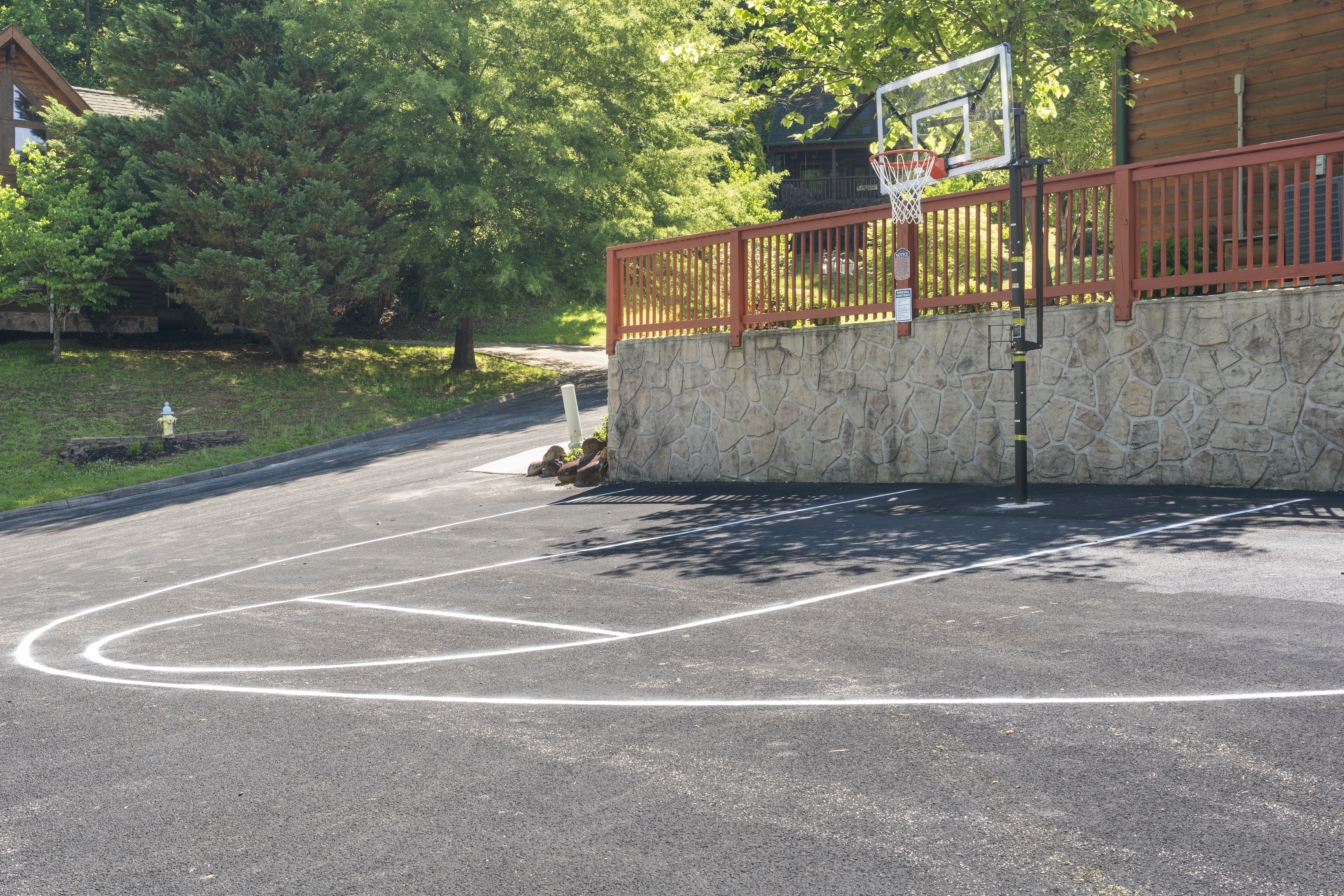A ground-level view of the shared community basketball court beside a building.