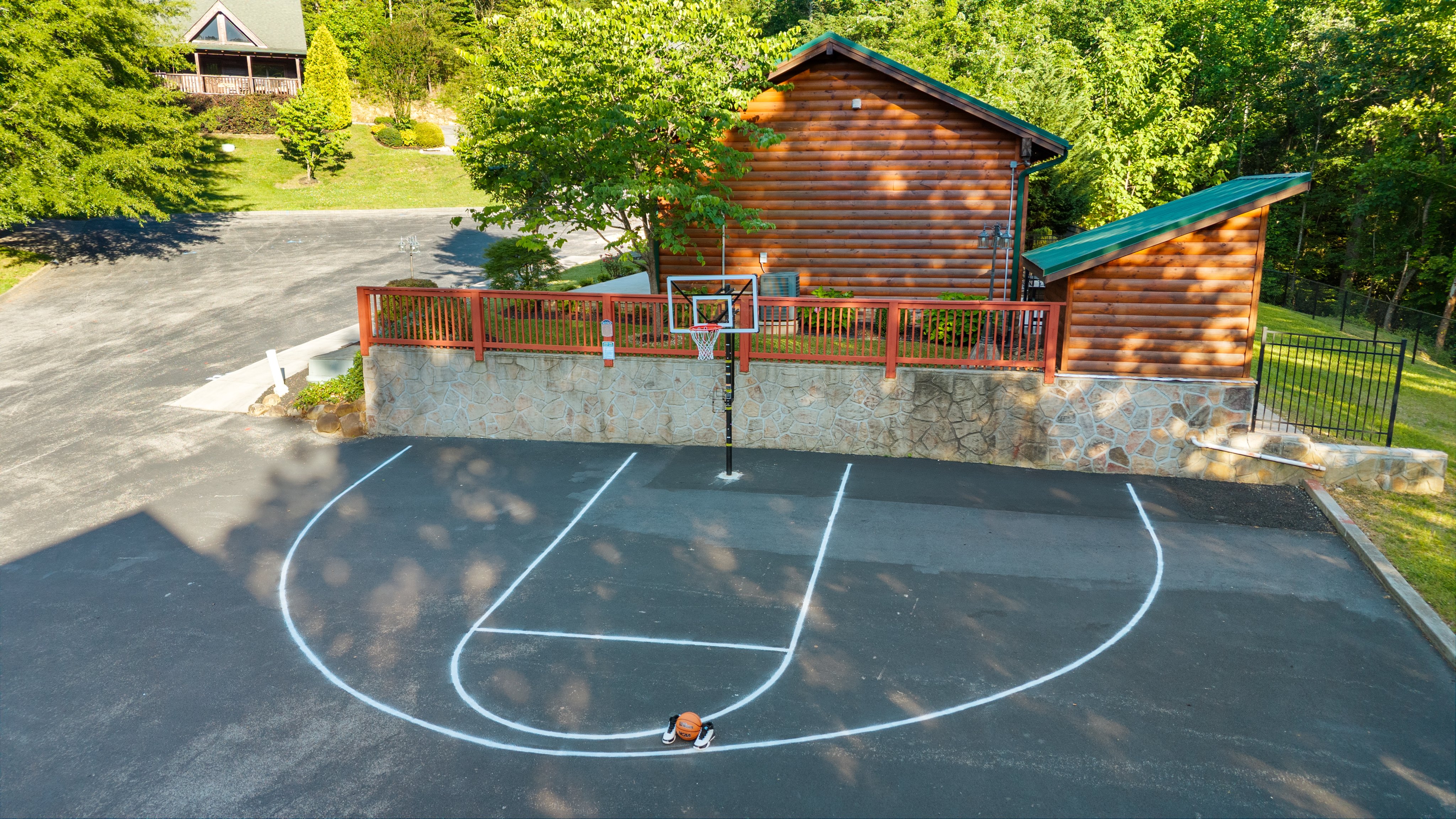 The shared community basketball half-court beside a building.