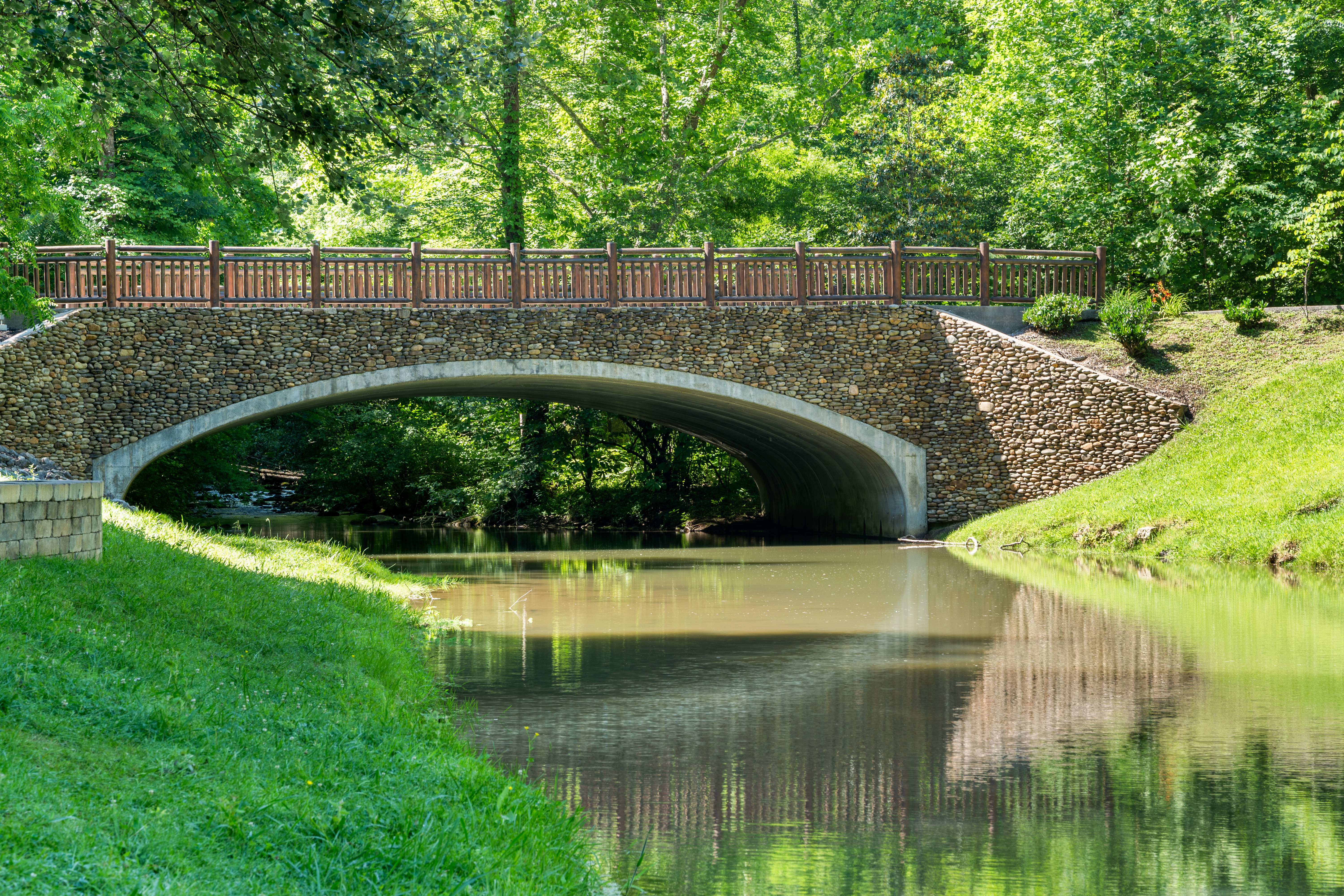 A stone bridge crossing a creek.