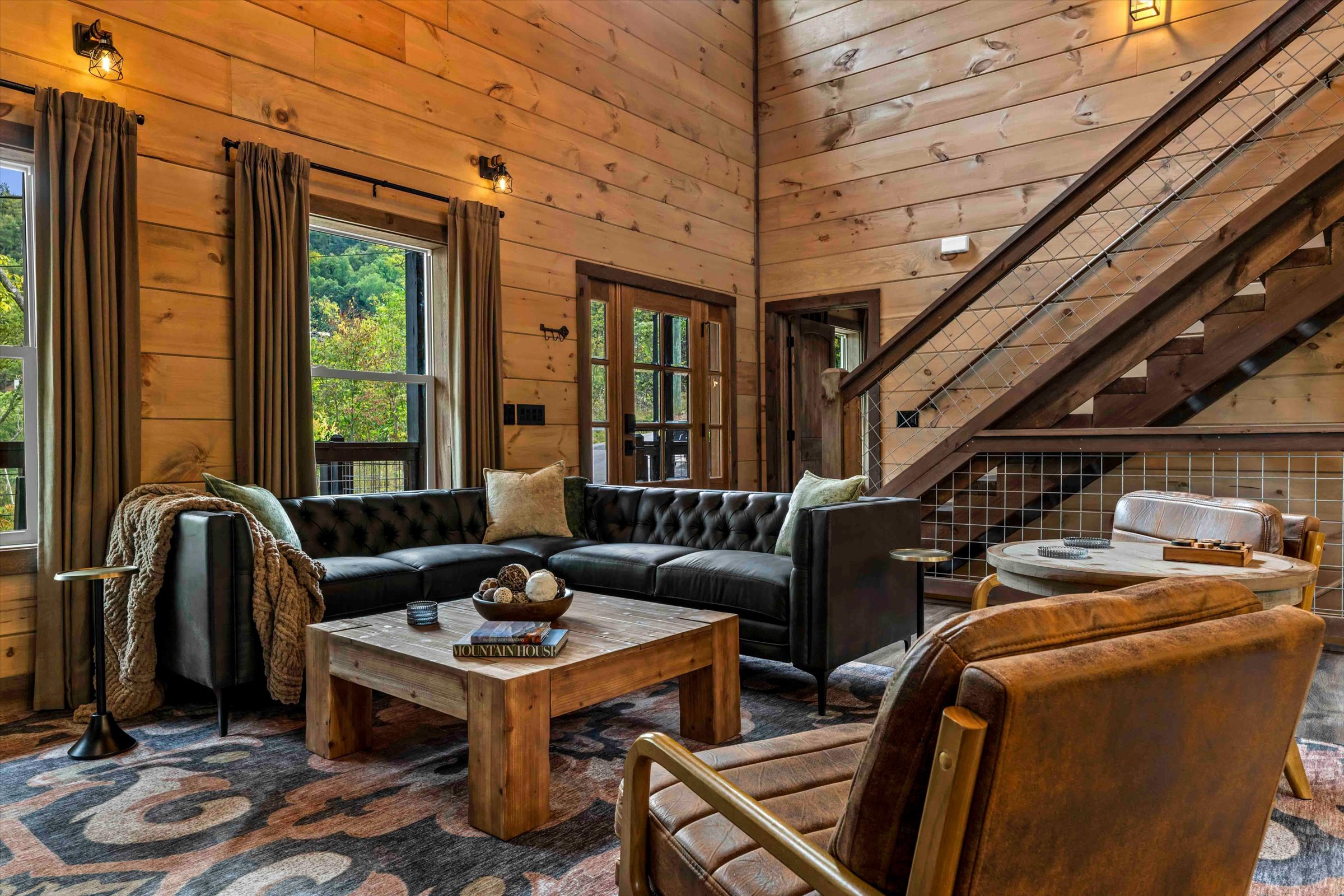 Warm wood-paneled great room with designer seating and scenic natural light