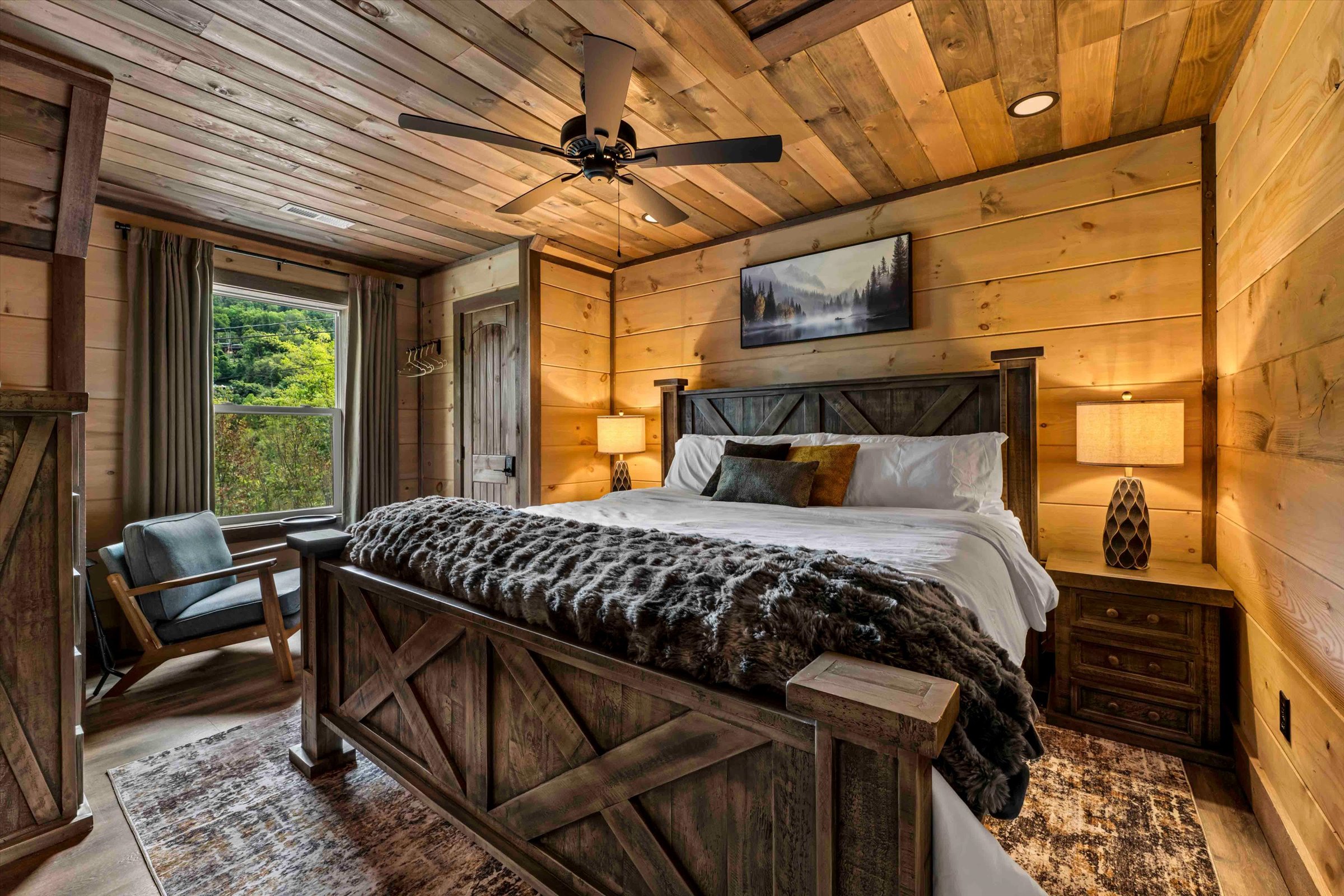 Cozy rustic king bedroom with forest views and warm cabin charm
