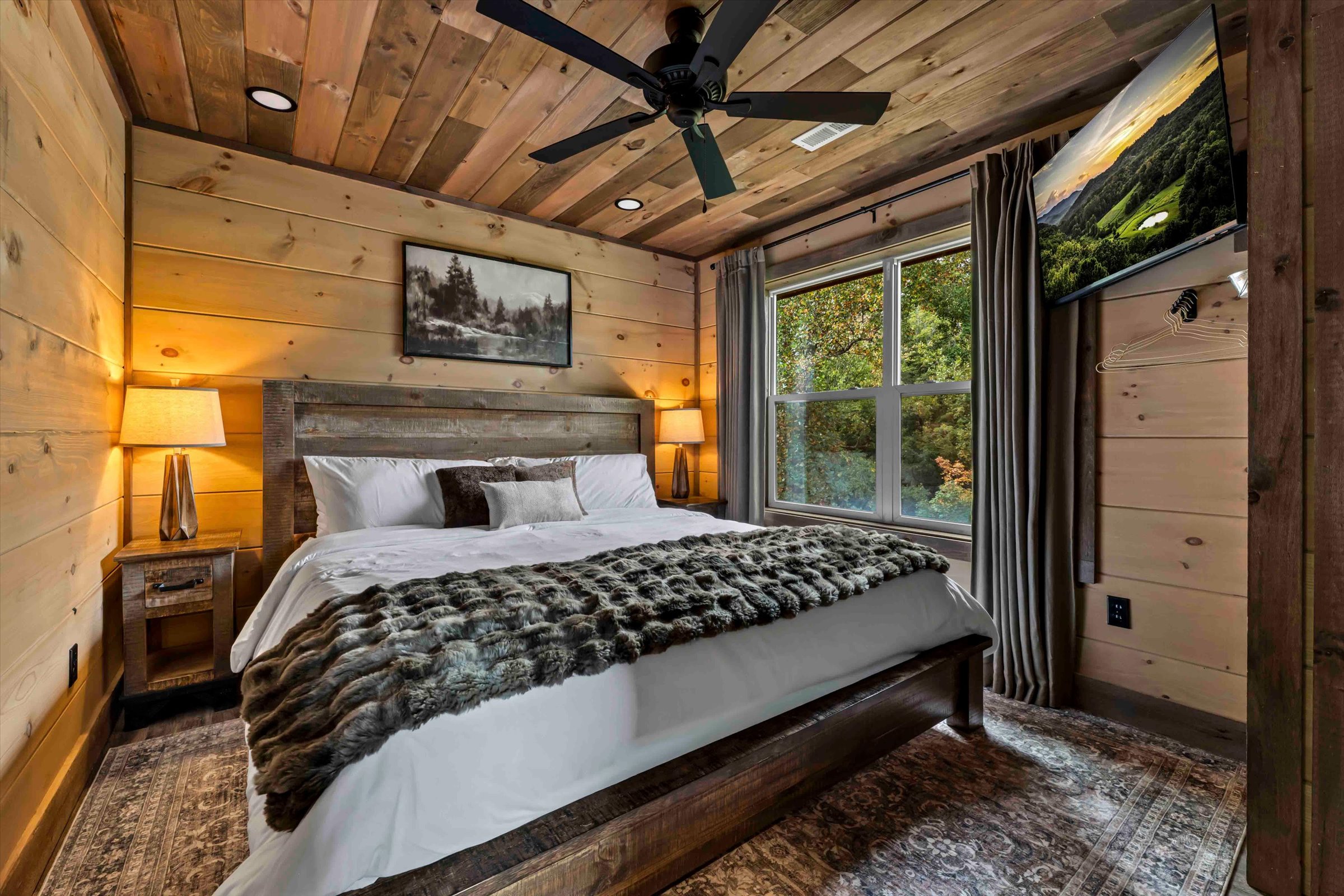 Cozy rustic king bedroom with forest views and warm cabin charm