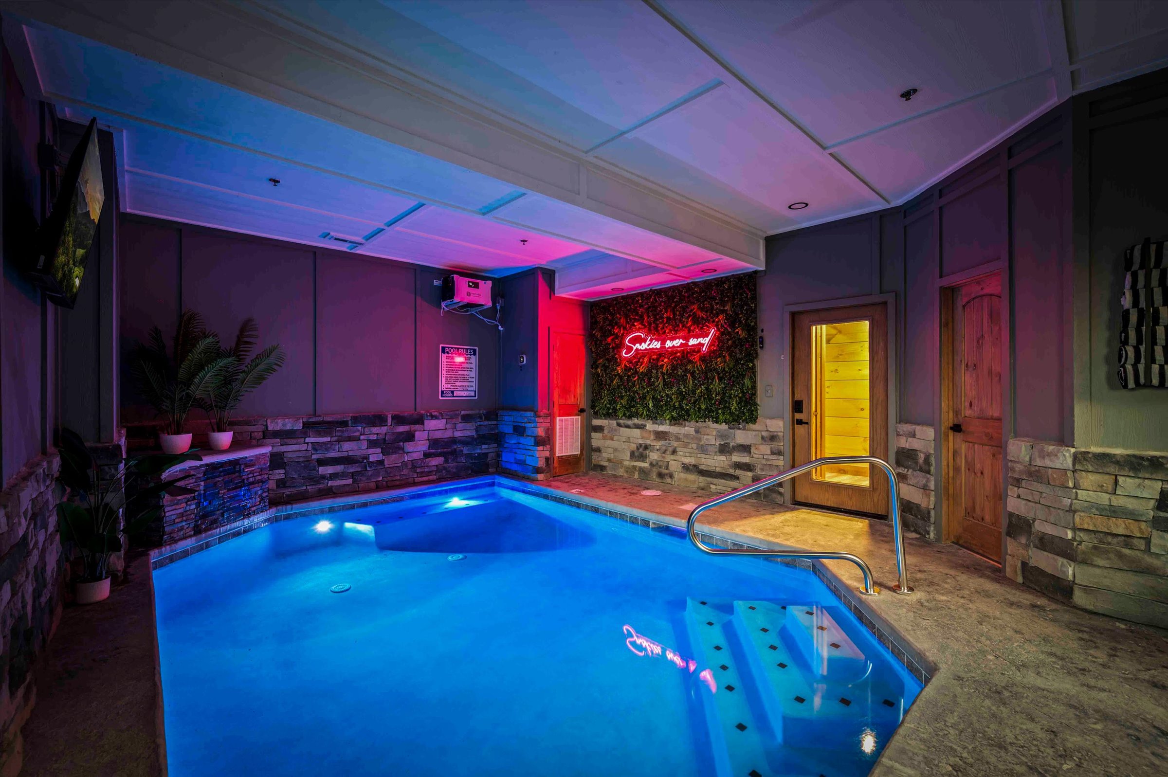 Private indoor pool with moody lighting and upscale spa-style ambiance