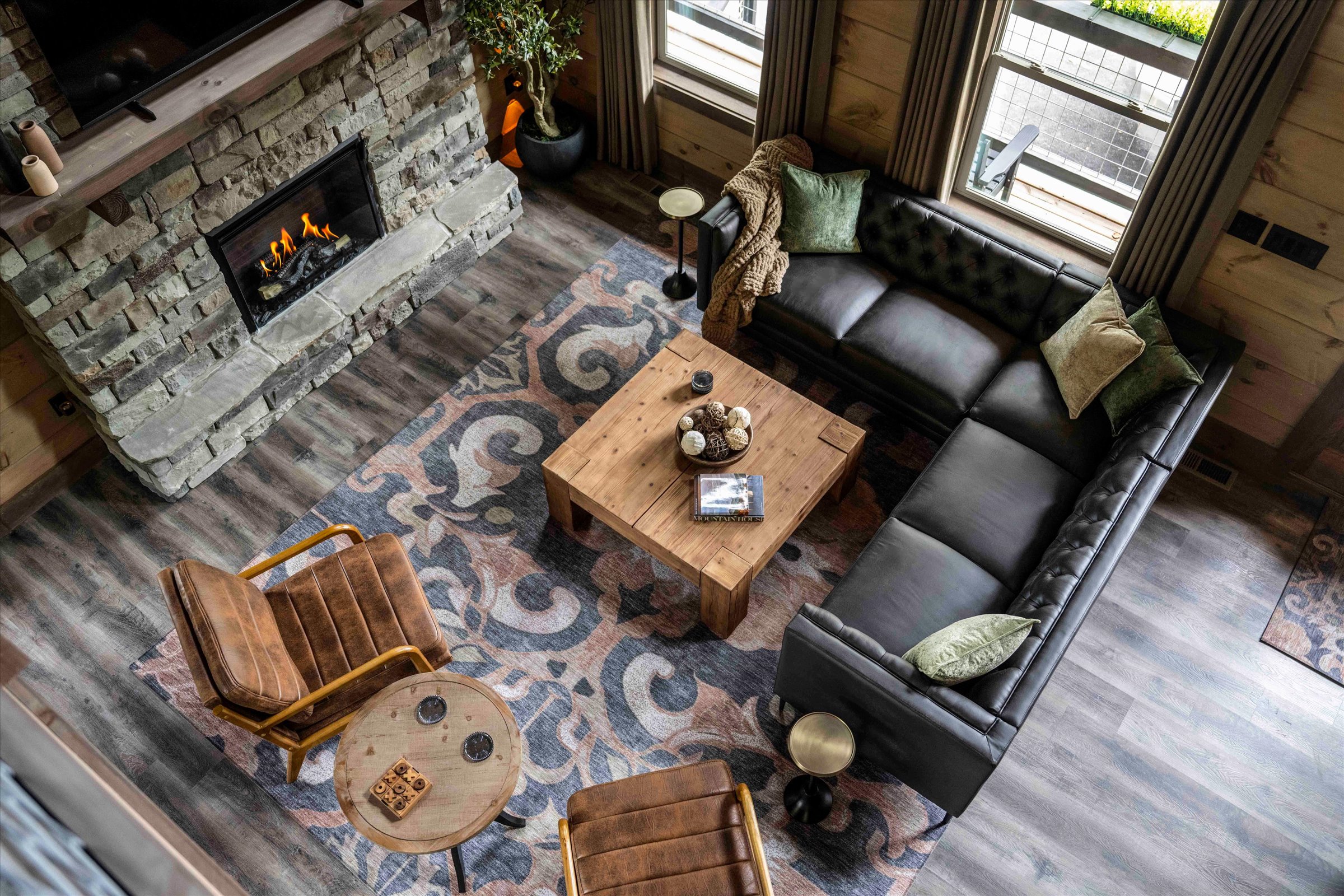 Cozy lodge-style living room with stone fireplace and spacious seating