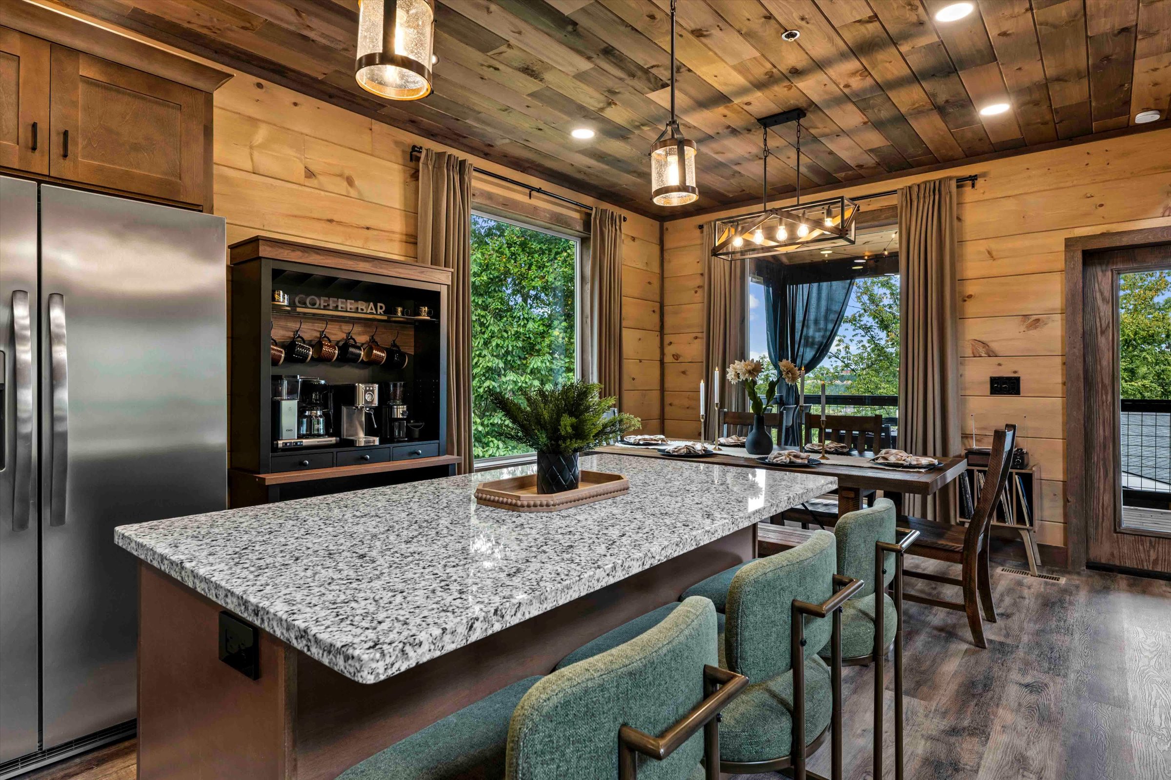 Rustic-chic kitchen with granite island, coffee bar, and scenic dining views