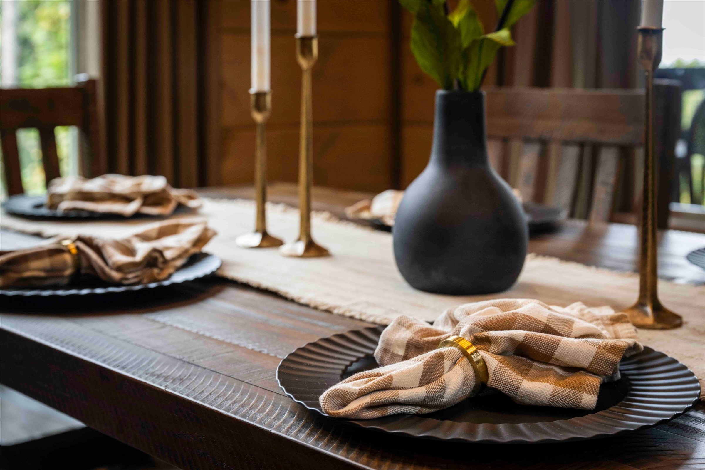 Warm rustic dining setup with elegant table styling and cozy cabin charm