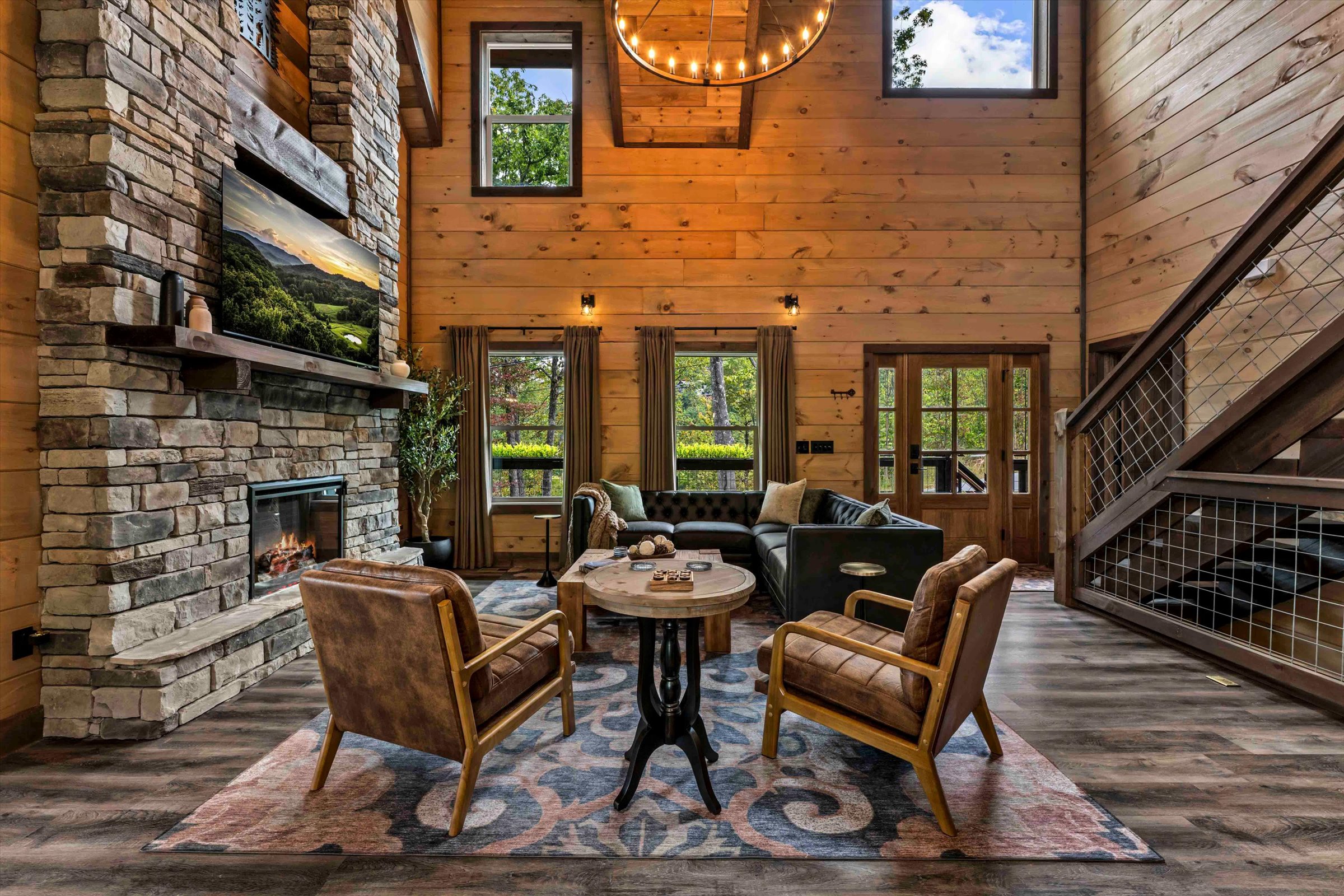 Grand lodge-style living room with stone fireplace and soaring ceilings